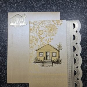 Metallic gold housewarming card an embossed house illustration and elegant floral
