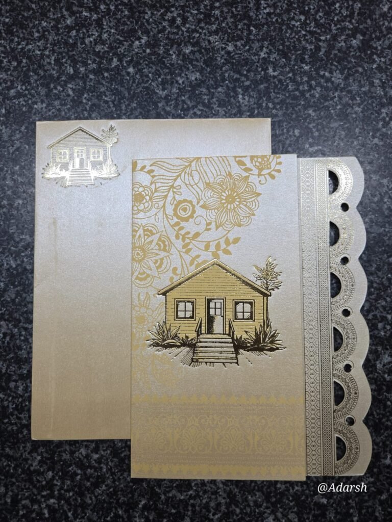 Metallic gold housewarming card an embossed house illustration and elegant floral