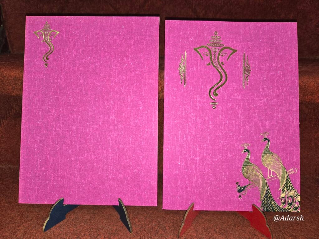 Lord Ganesha and gold foil peacock designs on a pink/magenta Card